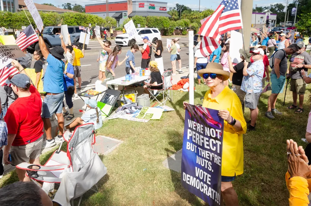 Rally goers, American flag and signs
