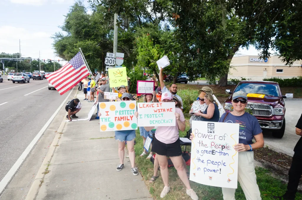 Rally goers, flag and signs