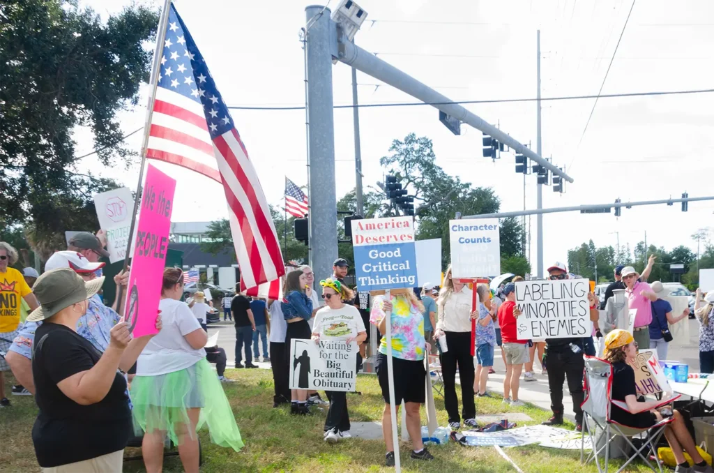 Rally goes and America Deserves Good Critical Thinking signs